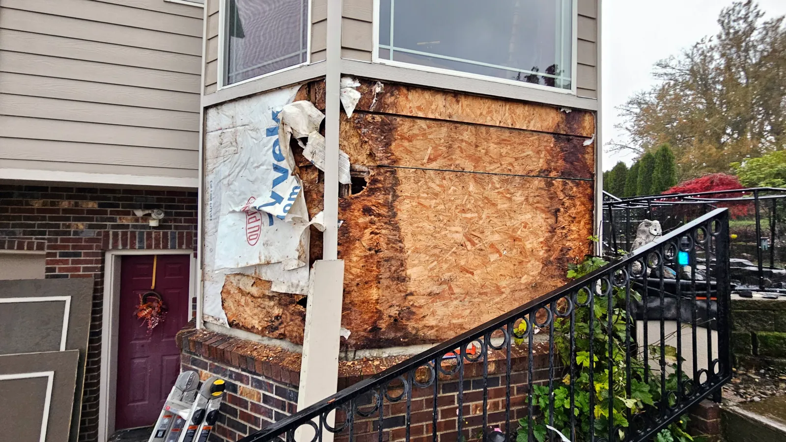 Before: rotted wall sheathing under a bay window